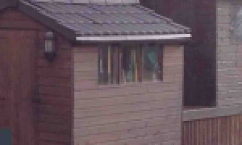 Image of two garden shed roof replacement with black Lightweight Tiles
