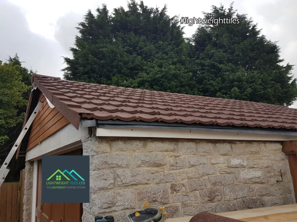 Close up image of brown granulated garage roof replacement by lightweight tiles