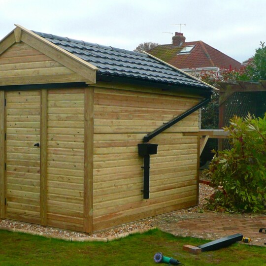 large garden shed with budget black roof tiles